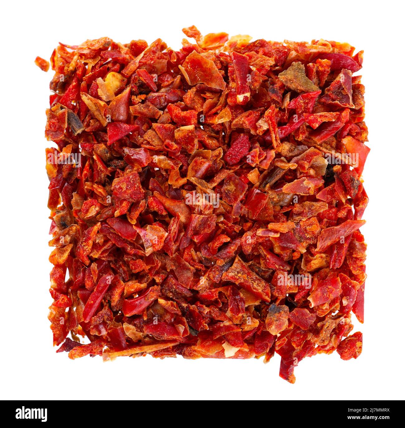 Dried red paprika flakes isolated on white background. Spices and herbs