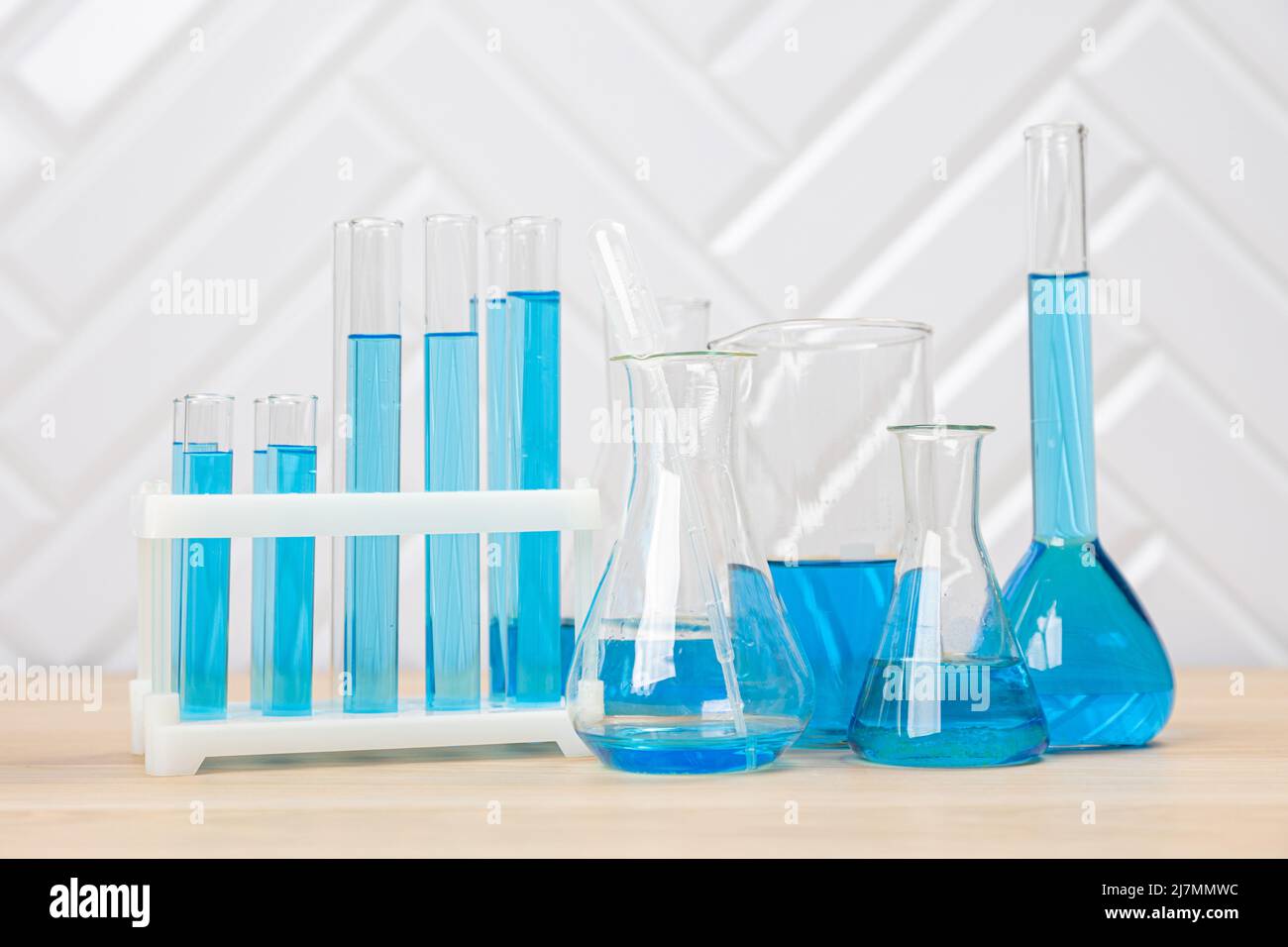 Laboratory glassware with blue liquid in a test tube. scientific ...