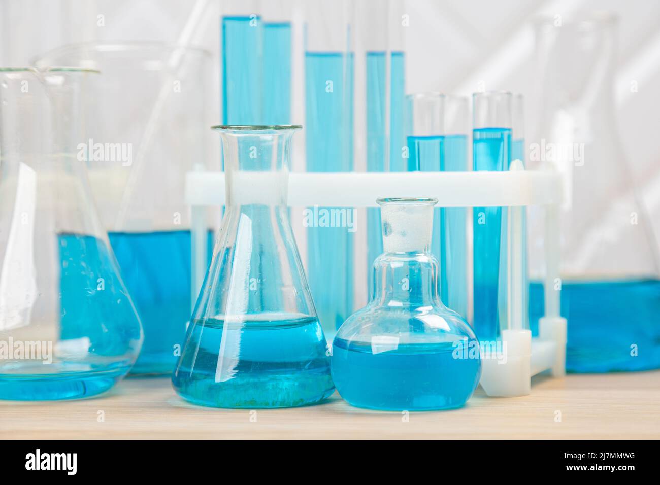 Laboratory glassware with blue liquid in a test tube. scientific ...