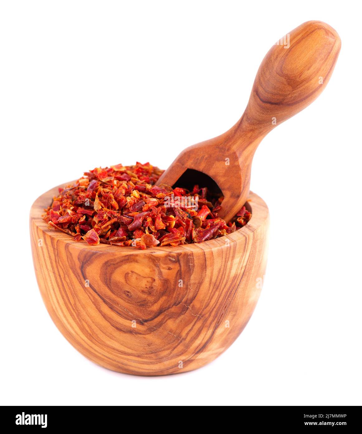 Dried red paprika flakes in olive bowl and scoop, isolated on white