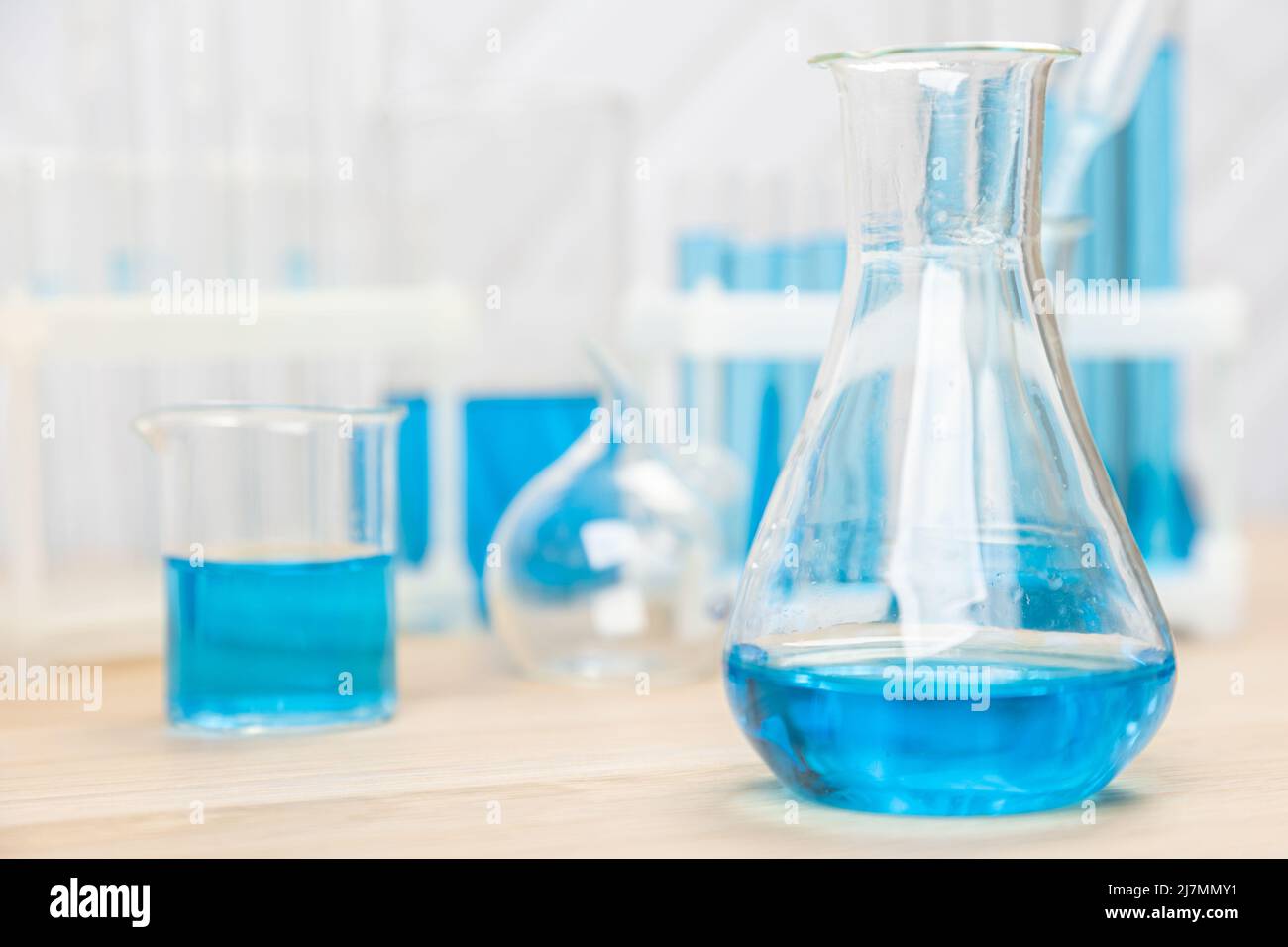 Laboratory glassware with blue liquid in a test tube. scientific ...