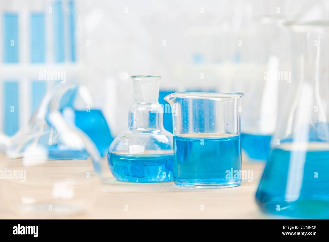 Laboratory glassware with blue liquid in a test tube. scientific ...