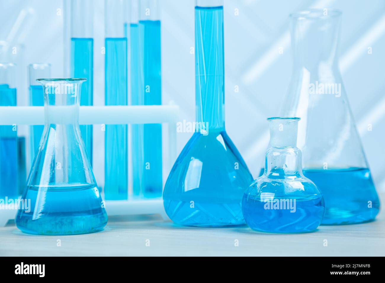 Laboratory glassware with blue liquid in a test tube. scientific ...