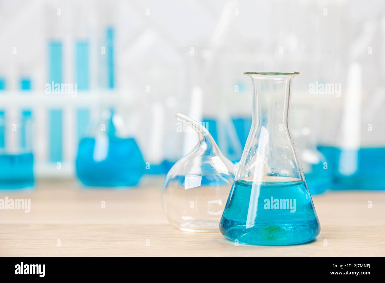 Laboratory glassware with blue liquid in a test tube. scientific ...