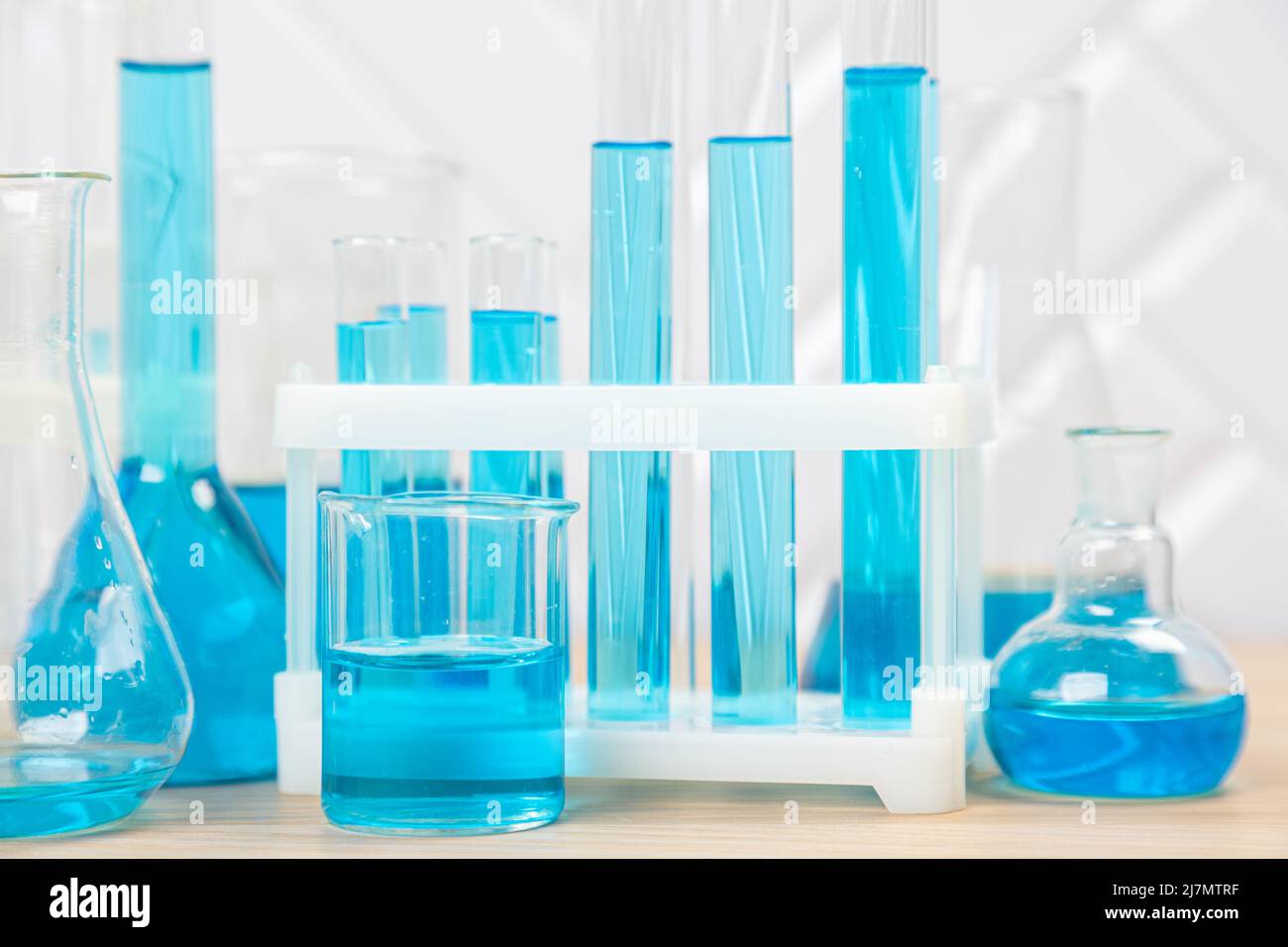 Laboratory glassware with blue liquid in a test tube. scientific ...