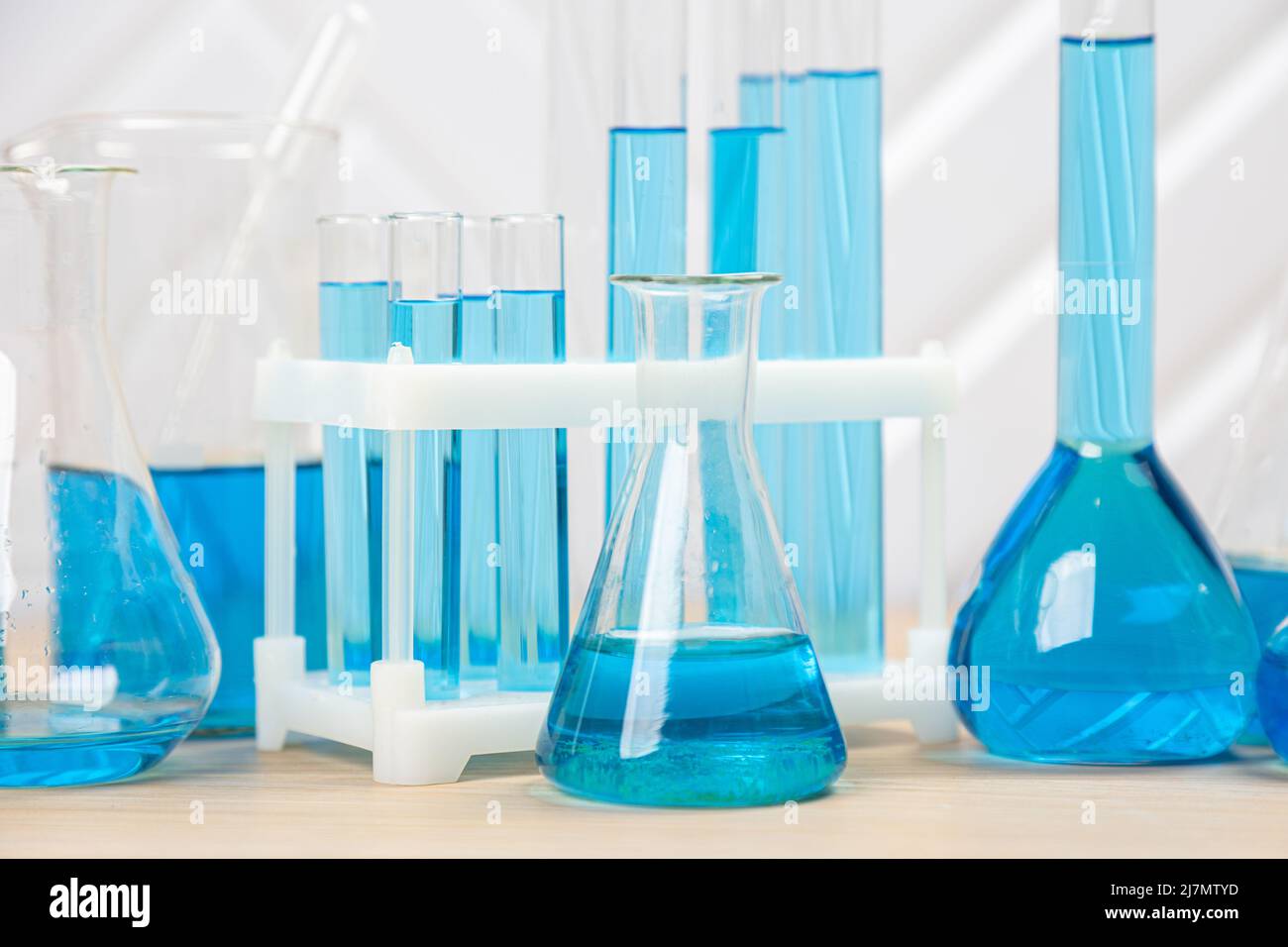 Laboratory glassware with blue liquid in a test tube. scientific ...
