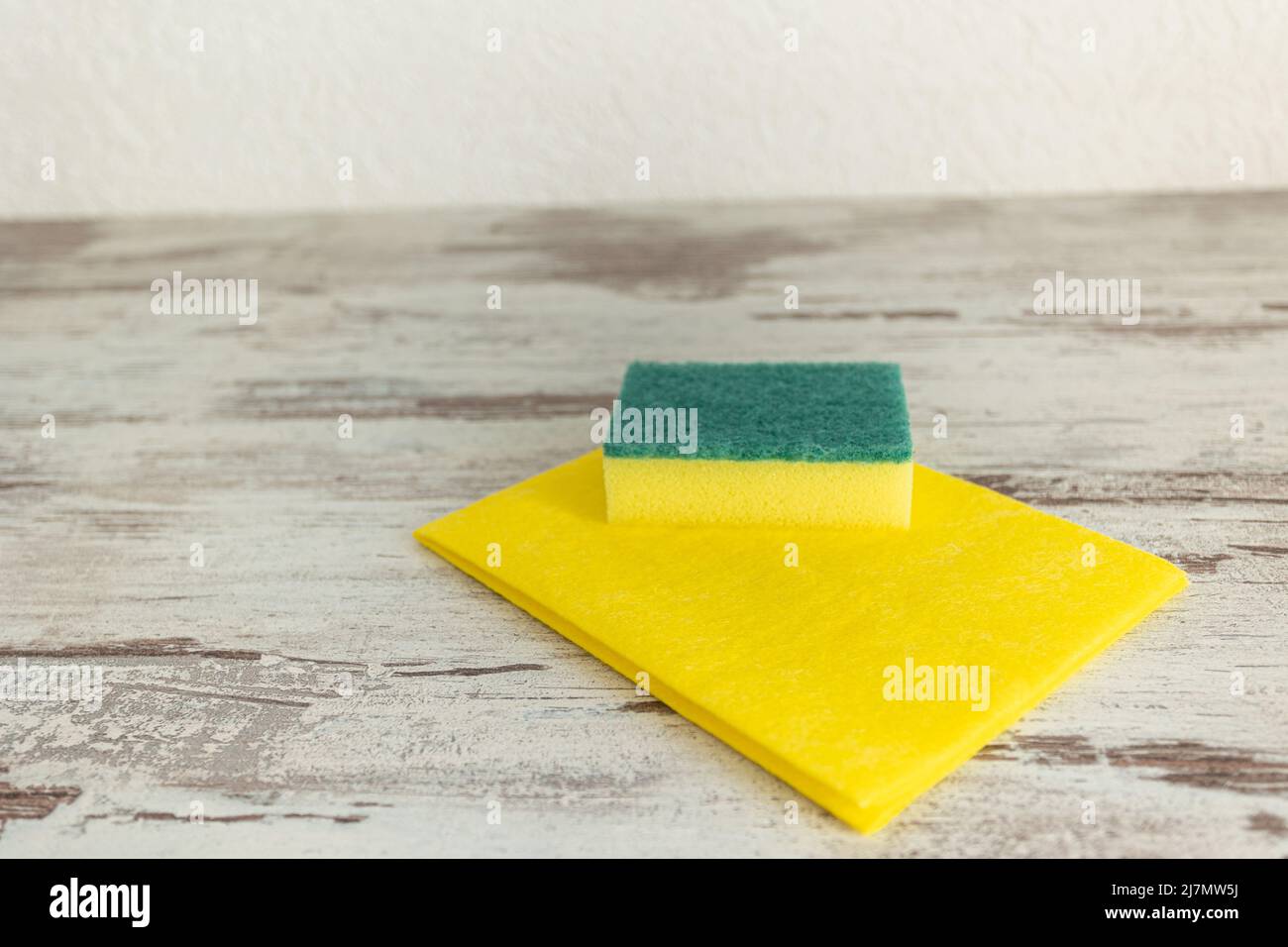 colored rags and sponges for cleaning various surfaces in the kitchen