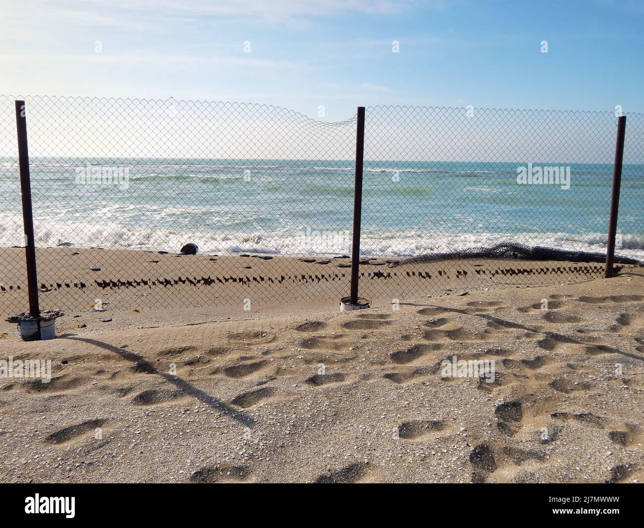 Sandy coast of the Caspian Sea. Mesh fence. Kazakhstan. Mangistau region. 04 February. 2020 year. Stock Photo