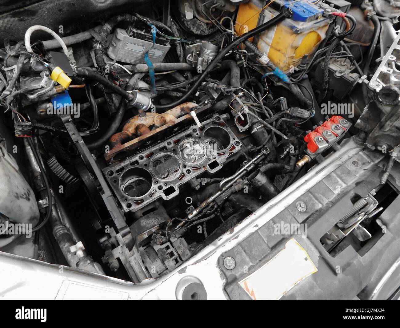 Disassembled engine under the hood of a car. Stock Photo