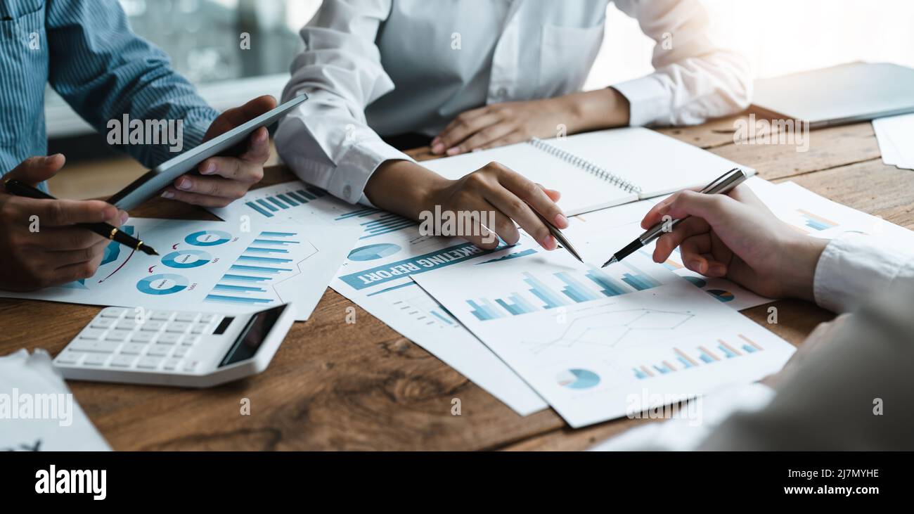 Businesspeople analyzing investment graph meeting brainstorming and discussing plan in meeting room, investment concept Stock Photo