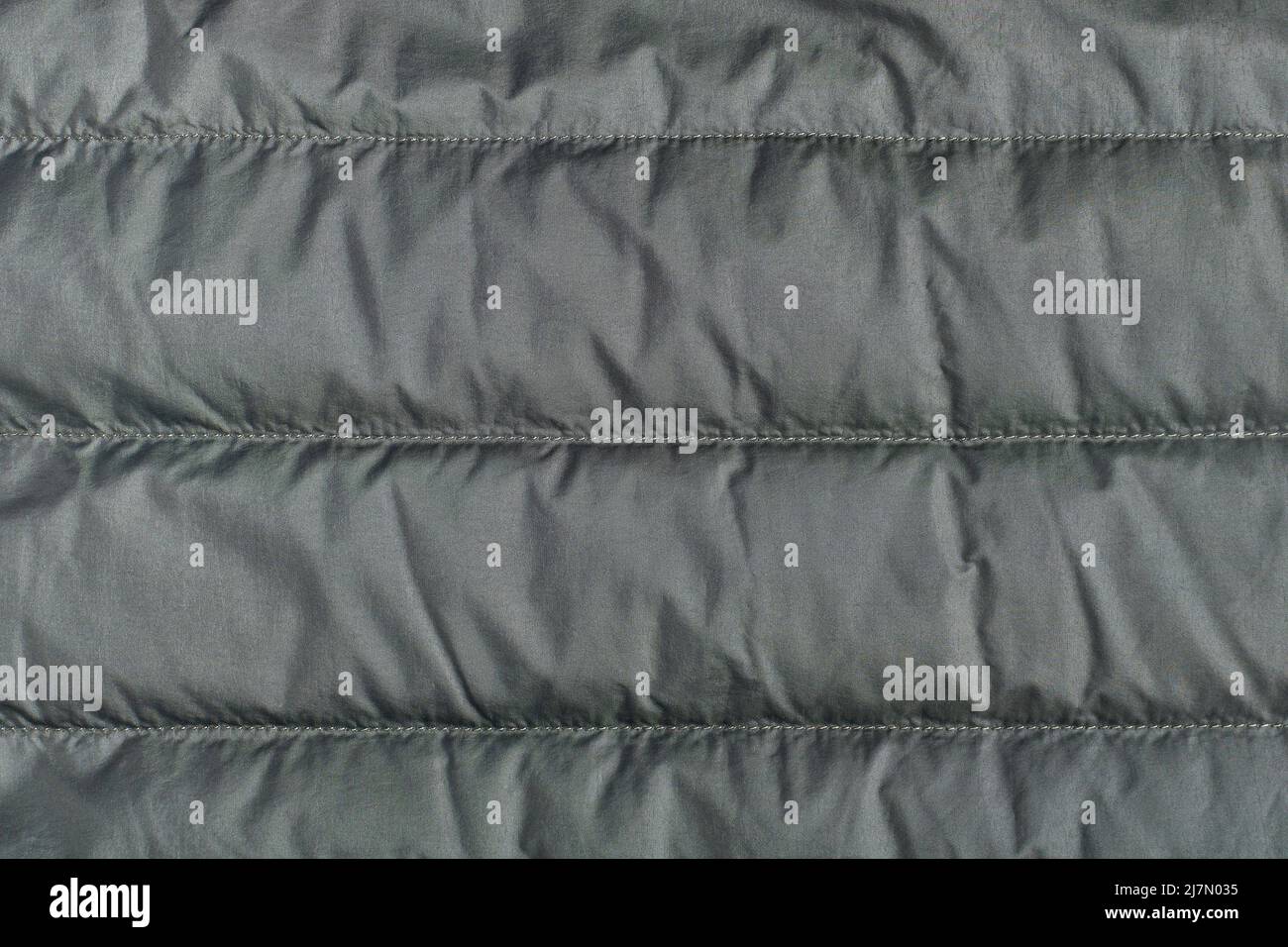 Textile background, green quilted polyamide down jacket texture Stock Photo