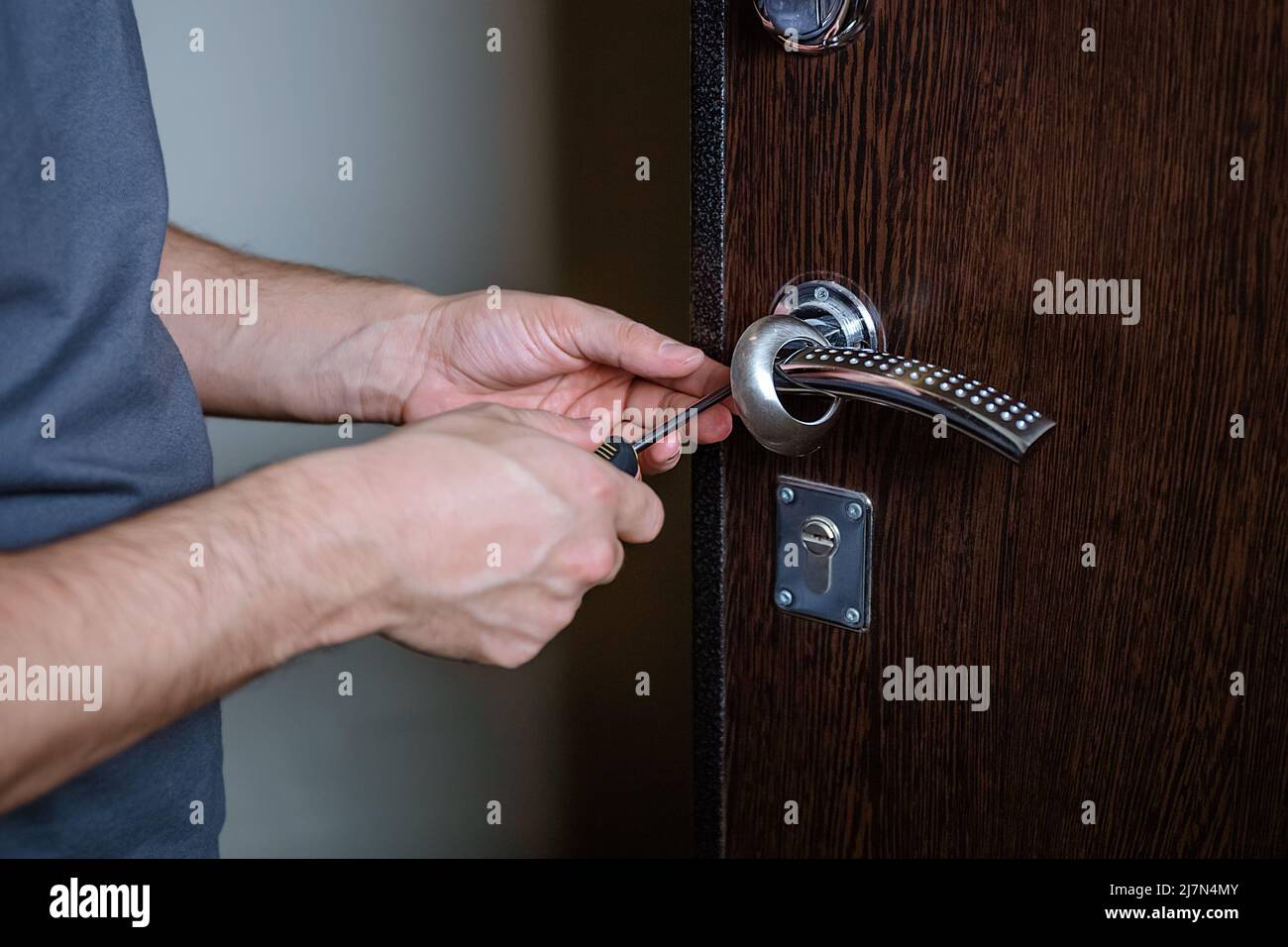 Locksmith replacing door lock to new after losing keys. Robbery