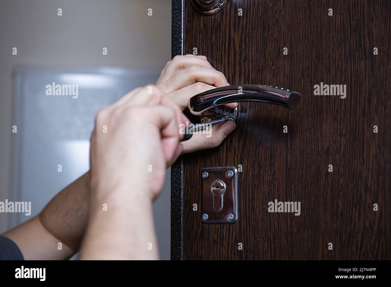 Locksmith replacing door lock to new after losing keys. Robbery