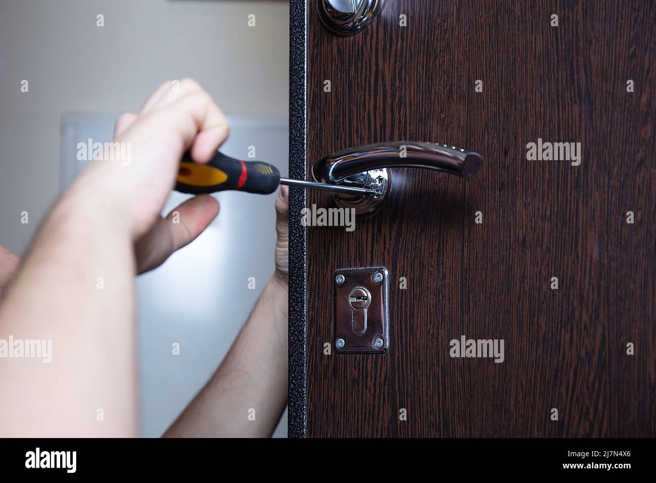 Locksmith replacing door lock to new after losing keys. Robbery