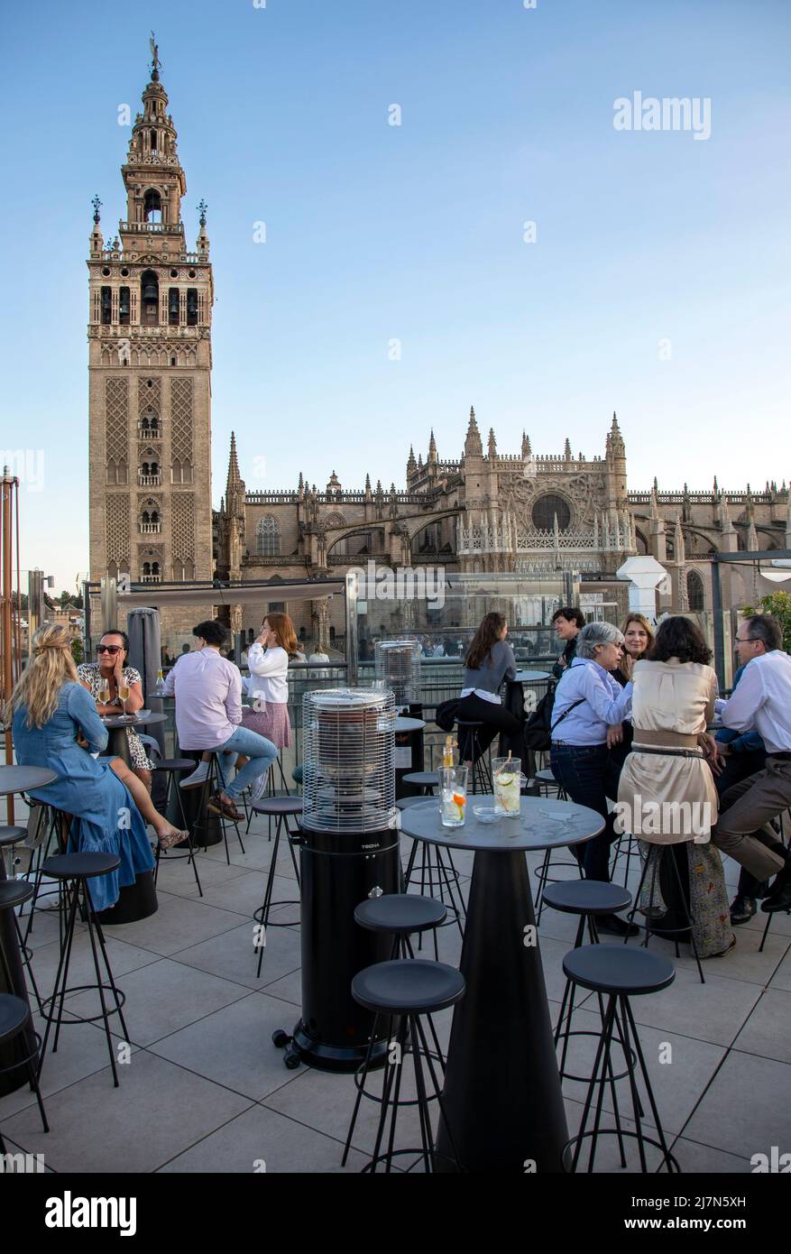 People drinking on the EME Cathedral Mercer Hotel rooftop bar overlooking  the Cathedral in Seville, Spain, as the sun sets. April 2022 Stock Photo -  Alamy