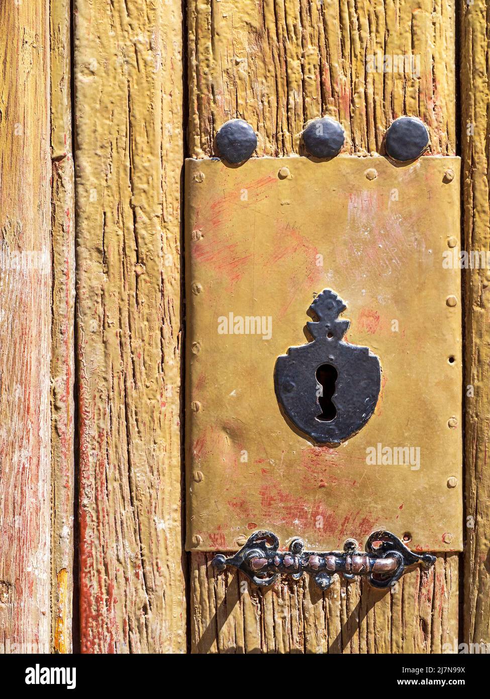 Old wooden door with lifted paintwork Stock Photo