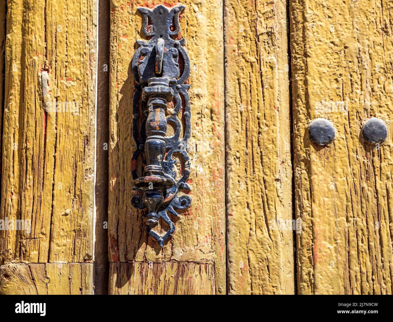 Old wooden door with lifted paintwork Stock Photo