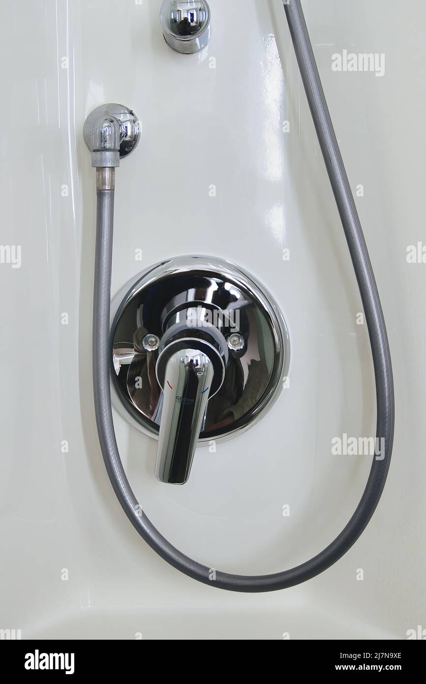 Modern shiny mixing faucet or mixer tap for the shower in a bathroom Stock Photo
