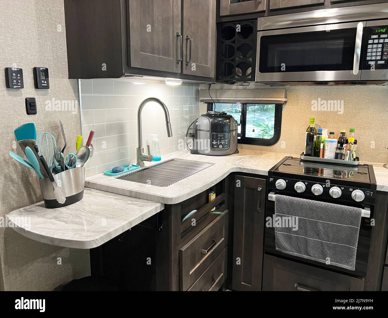 Modern luxury RV caravan kitchen interior with pressure cooker air fryer multi use cooker. Stock Photo
