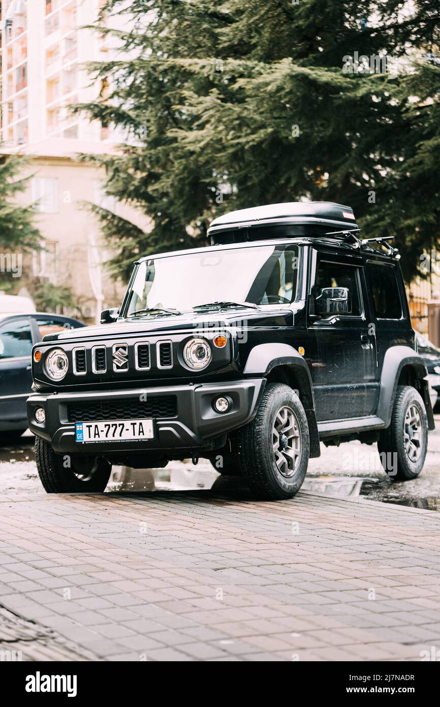 Black Suzuki Jimny car parked on street. fourwheel drive offroad mini