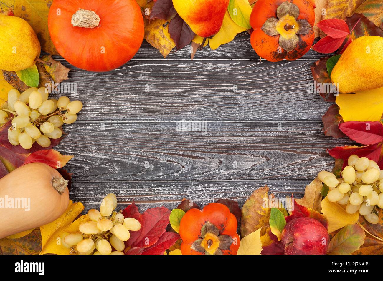 autumn leaves fruits vegetable frame on wood background Stock Photo