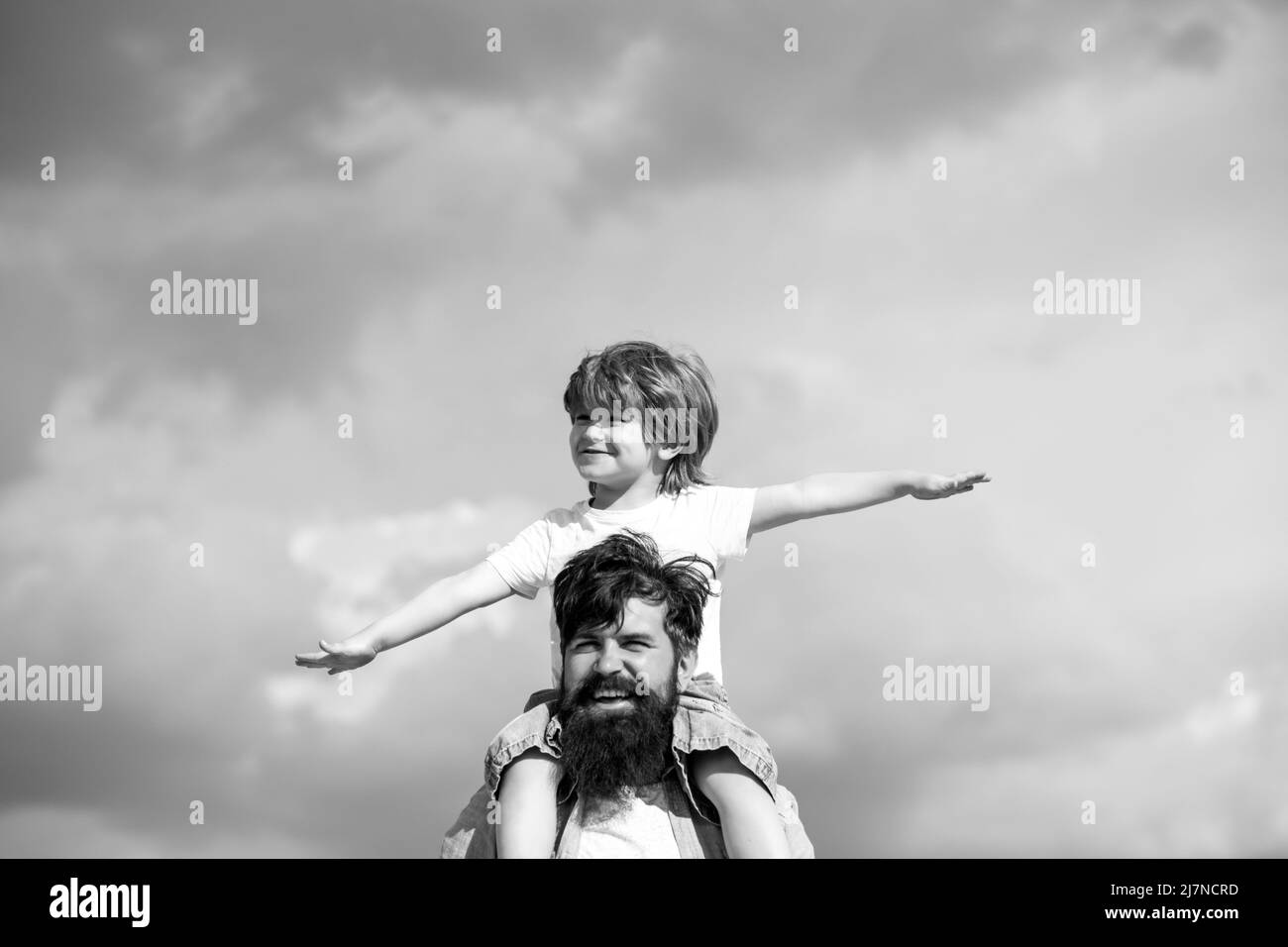 Father and son playing together. Child sits on the shoulders of his father. Family Time. Stock Photo