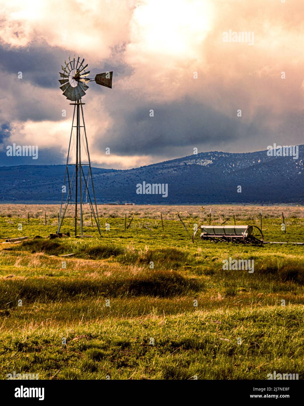 The image captures my favorite old Aermotor in Lassen County, California USA on a late spring afternoon during some very unsettled weather conditions. Stock Photo