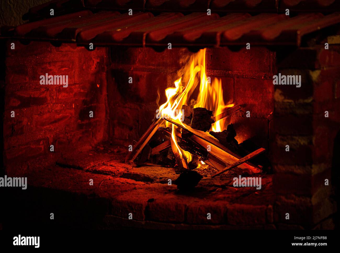 photograph of flames in the fireplace. Burning wood. Brick fireplace Stock Photo