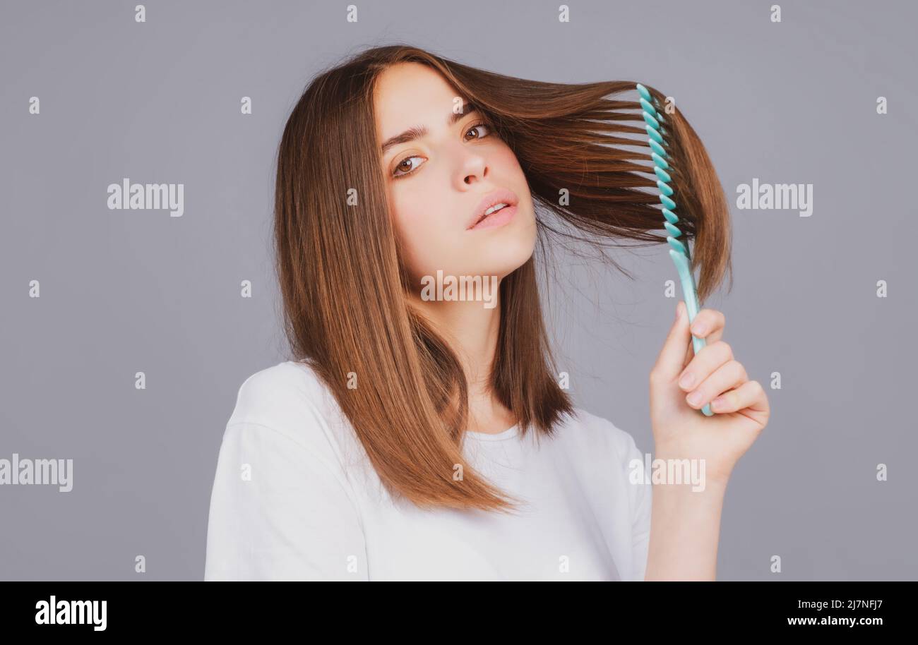 Woman brushing straight natural hair with comb. Girl combing long ...