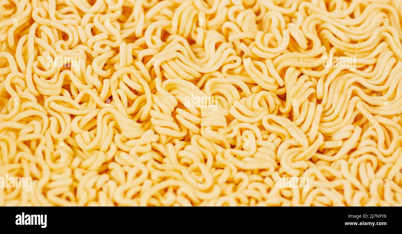 Texture of dry instant noodles. Background texture of dry pasta without