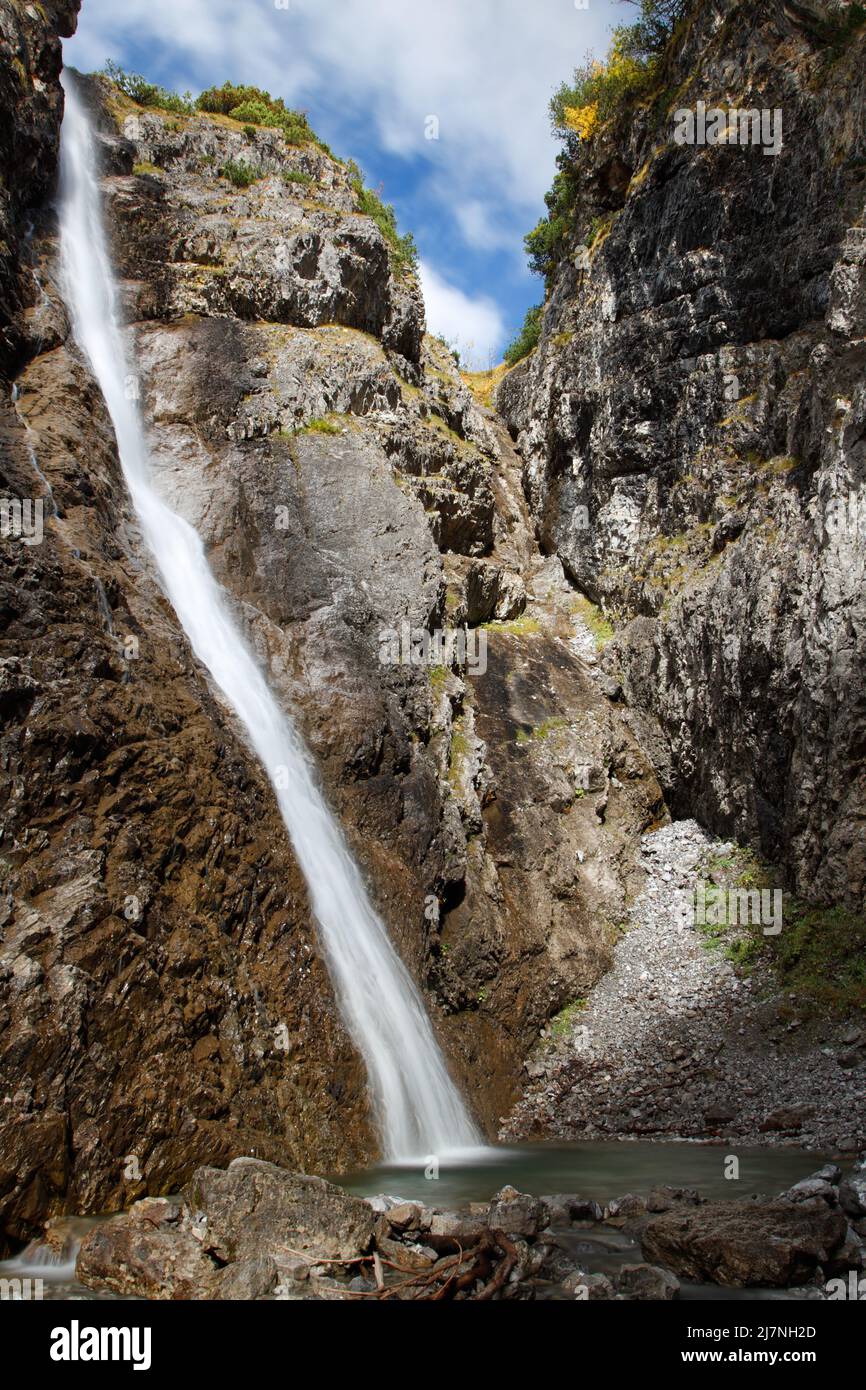 Thin and high waterfall in Austrian Alps Stock Photo