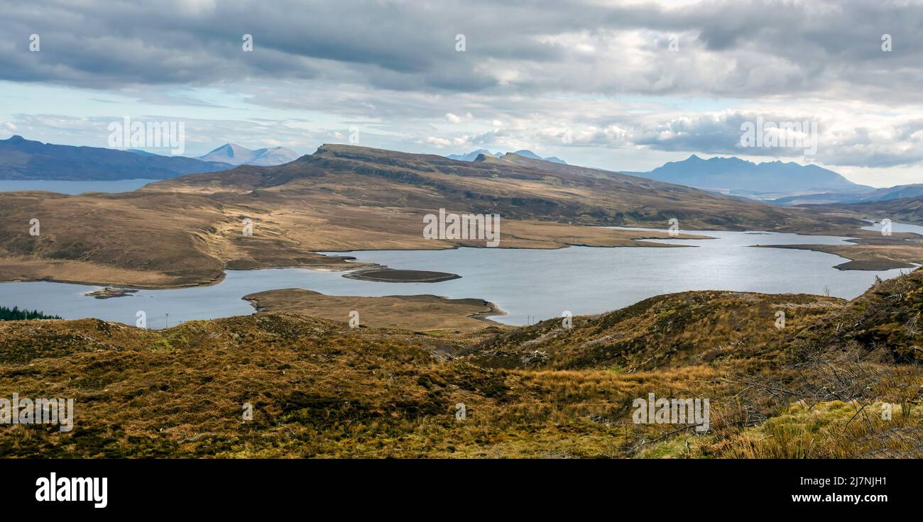 A panorama of Loch Leathan and the distant mountains as viewed from the Old Man of Storr on the Isle of Skye in Scotland, UK Stock Photo