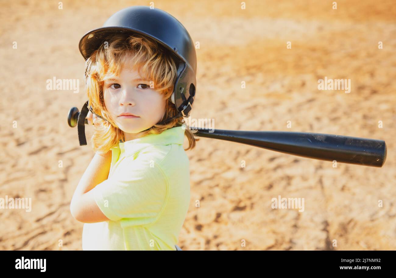 Child batter about to hit a pitch during a baseball game. Kid baseball