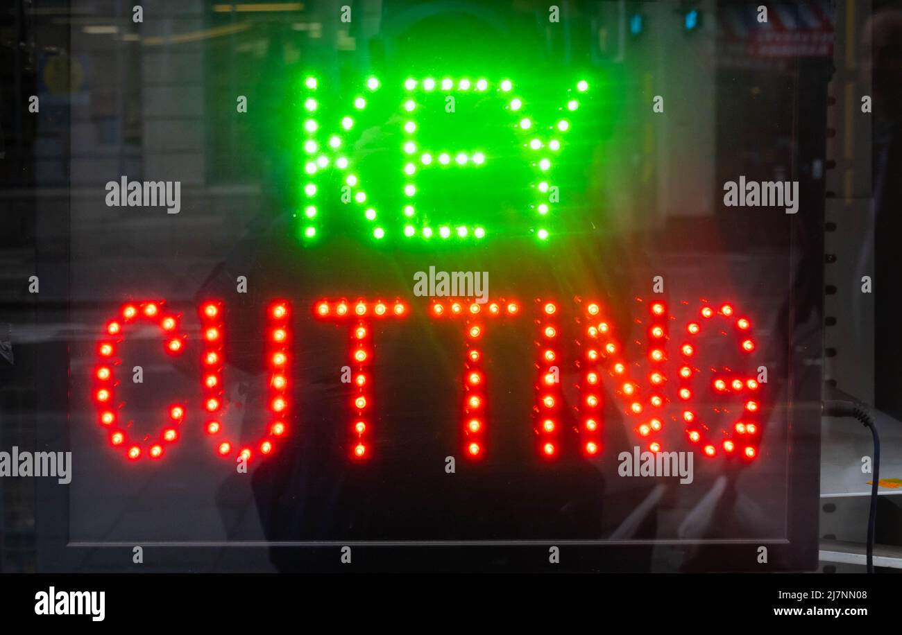 Lighted key cutting sign in a hardware store window Stock Photo Alamy