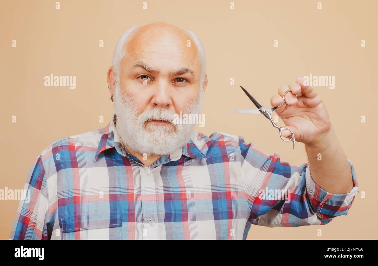 Old man with barber scissors. Barber shop concept Stock