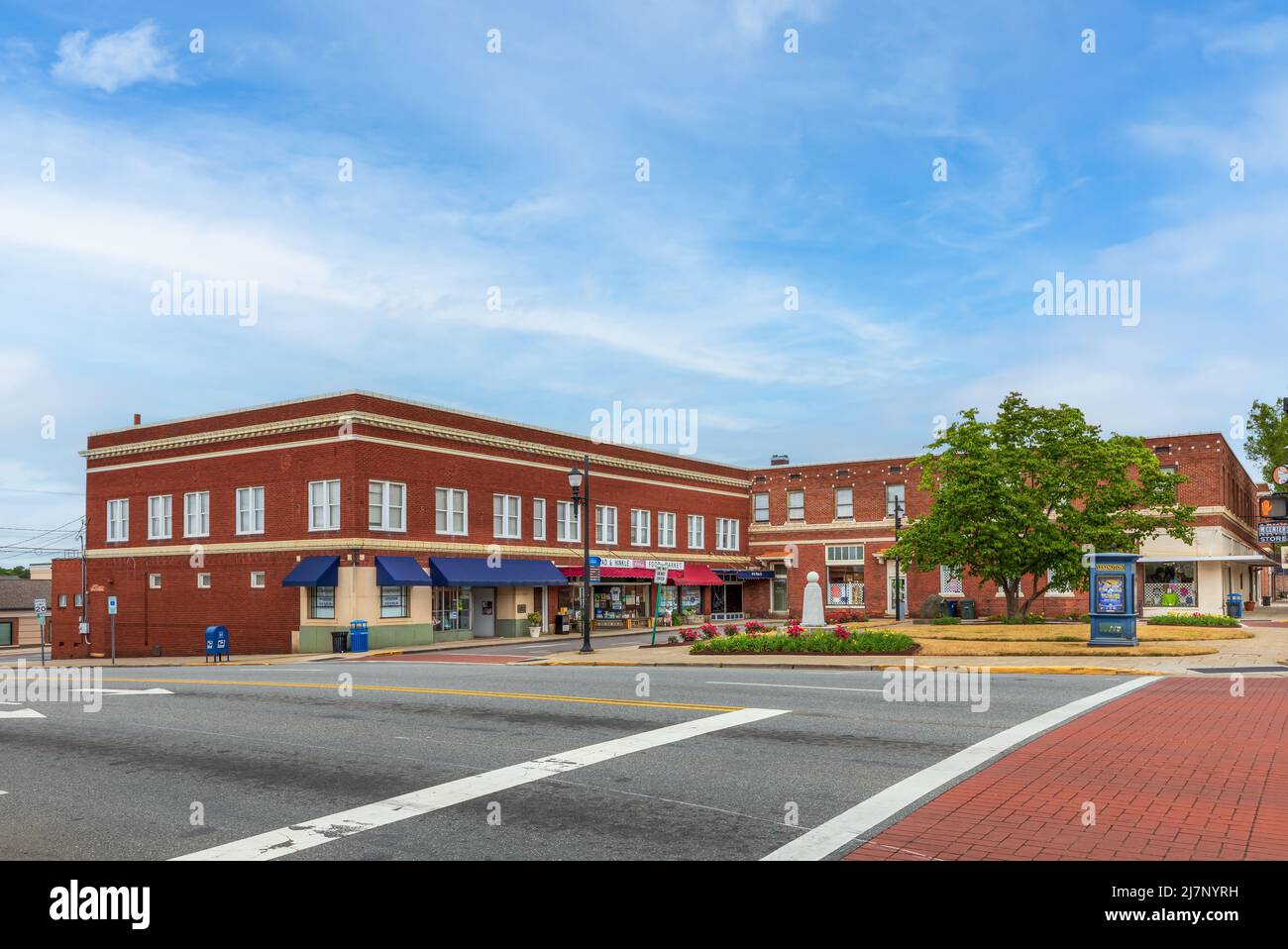 LEXINGTON, NC, USA-8 MAY 2022: Wide angle view of Main St. corner showing small commons area and vintage store buildings, information kiosk, food mark Stock Photo