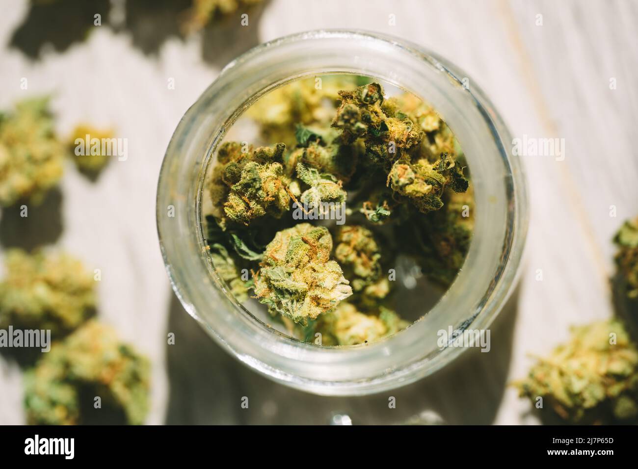 Close up of medical marijuana or cannabis flower buds in glass jar Stock Photo