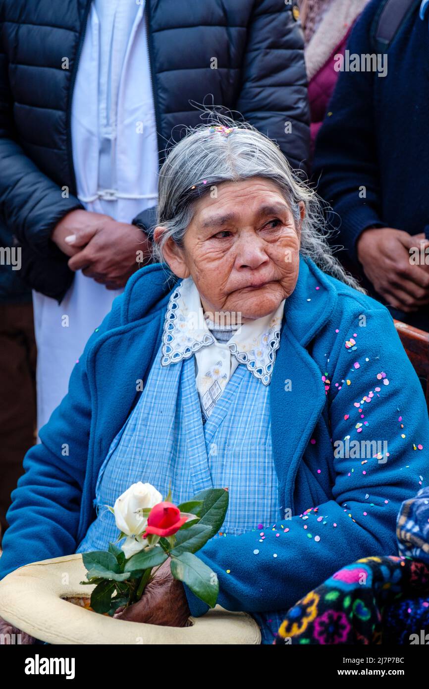 Senior Peruvian woman, devotee at a religious festival in Ollantaytambo, Urubamba Valley, Peru Stock Photo