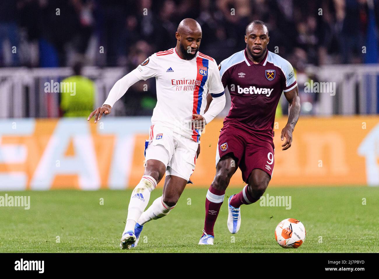 LYON, FRANCE - APRIL 14: Moussa Dembele of Lyon (L) is chased by Michail Antonio of West Ham (R) during the UEFA Europa League Quarter Final Leg Two m Stock Photo