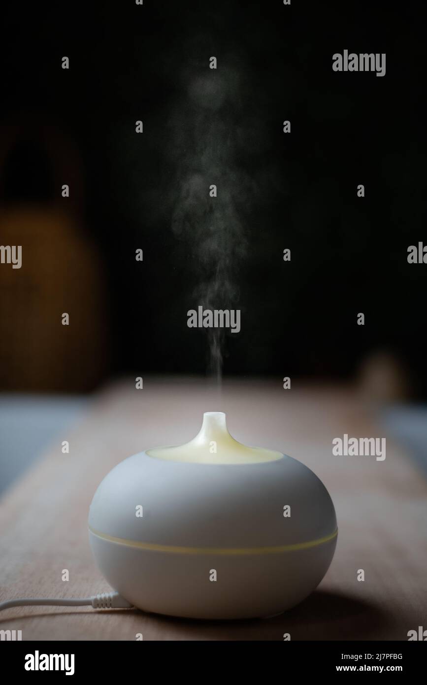 essential oil diffuser. electric aromatherapy device. steam against