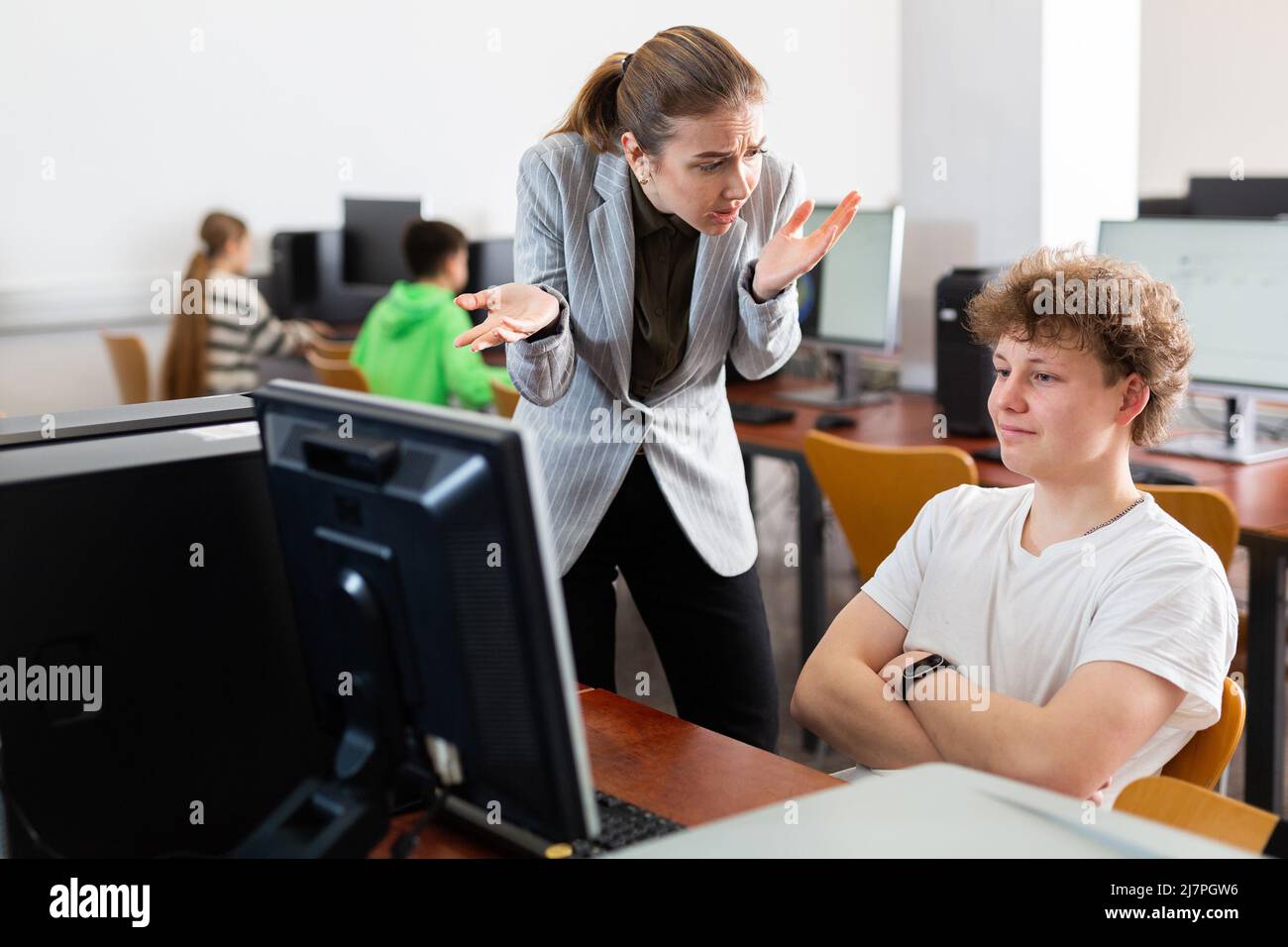 Teacher shouting at young boy student Stock Photo Alamy