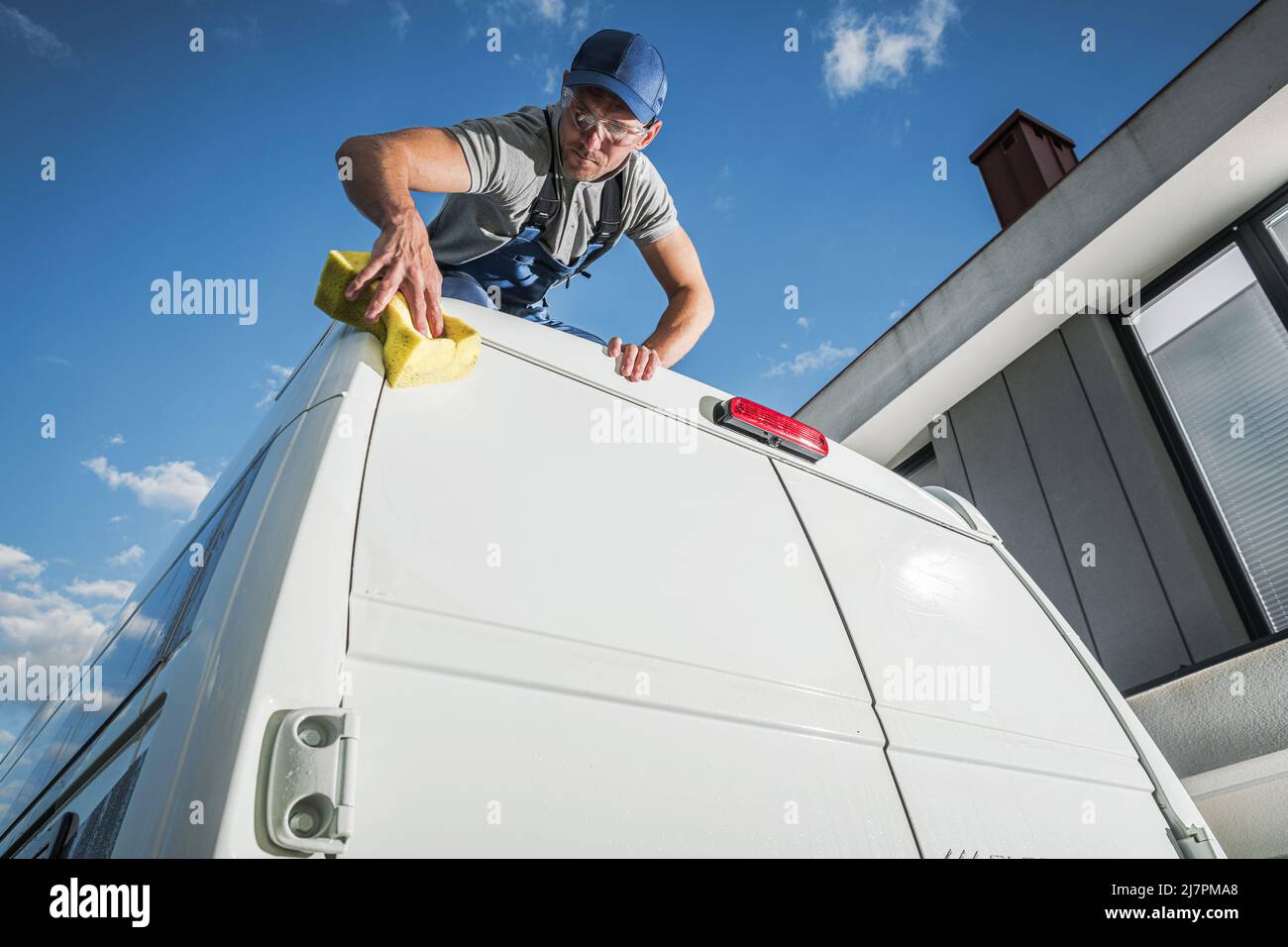 Caucasian Men Washing His Camper Van Class B Motorhome For