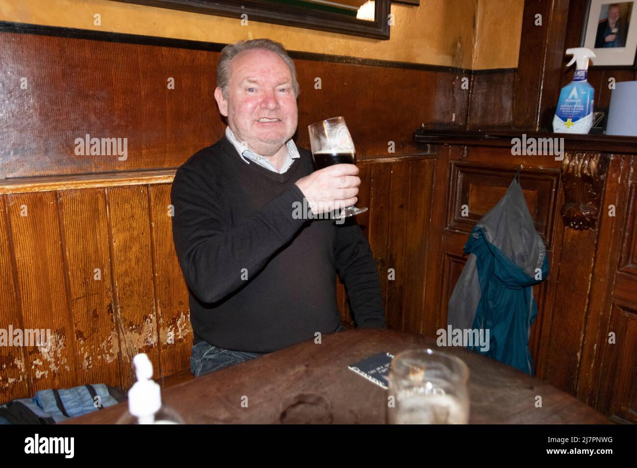 Man enjoys a tasty glass of beer, at John Kavanagh "The Gravediggers" pub Stock Photo