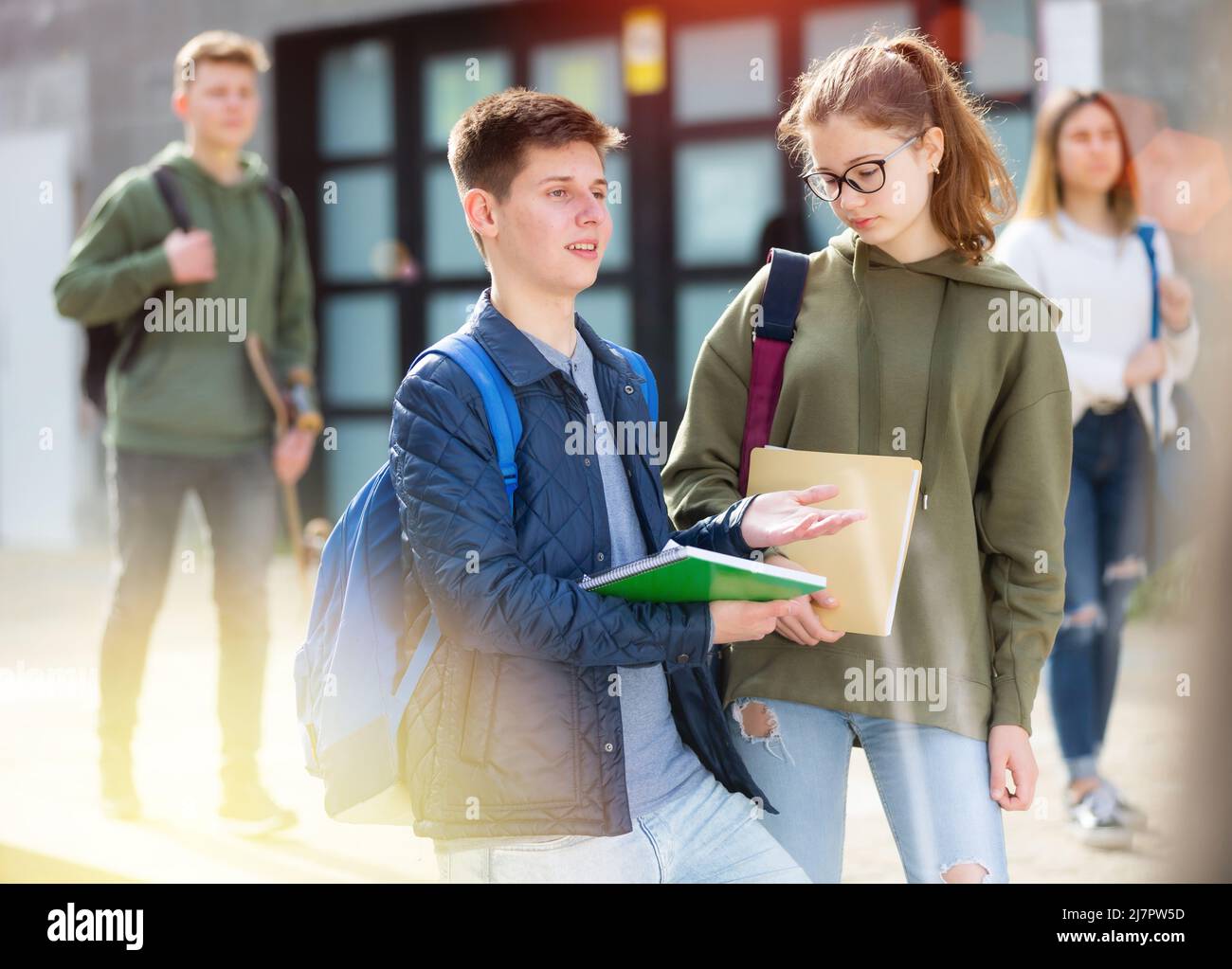 Teenage boy and girl discuss homework Stock Photo - Alamy