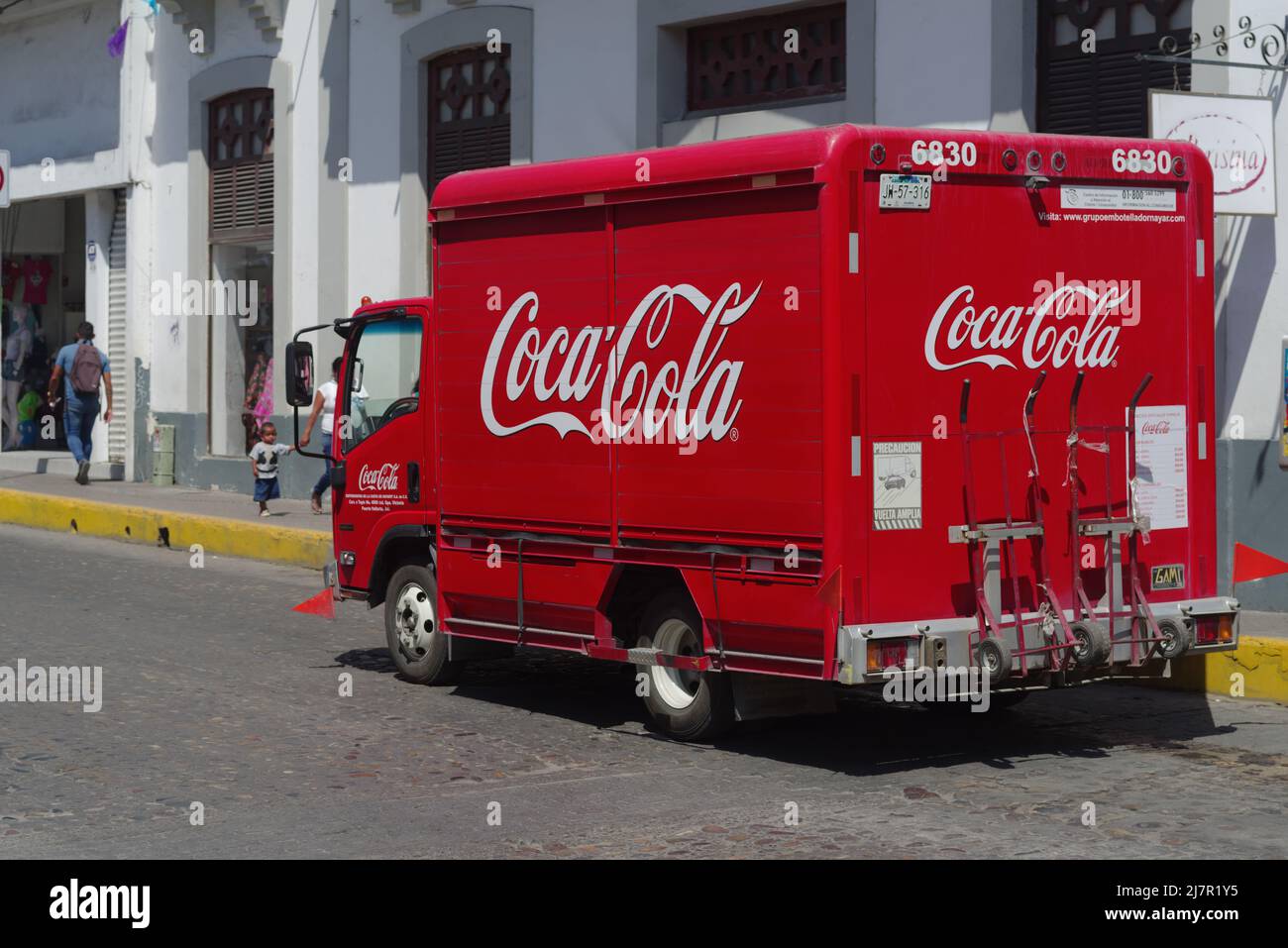 Image of a Coca Cola delivery truck shown driving in the town of Puerto Vallarta. Stock Photo