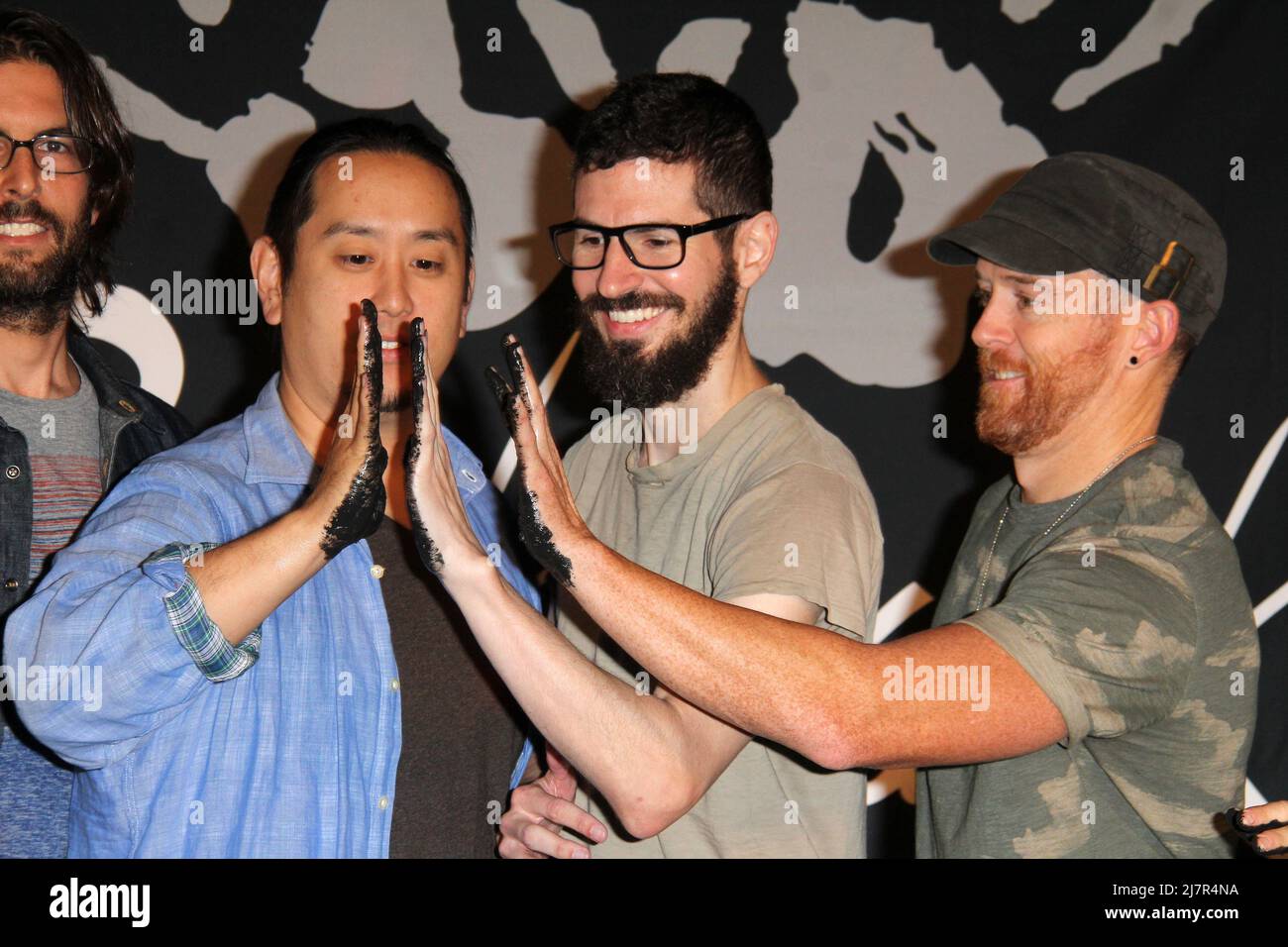 LOS ANGELES - JUN 18:  Joe Hahn, Brad Delson, Dave Farrell at the Linkin Park Rockwalk Inducting Ceremony at the Guitar Center on June 18, 2014 in Los Angeles, CA Stock Photo