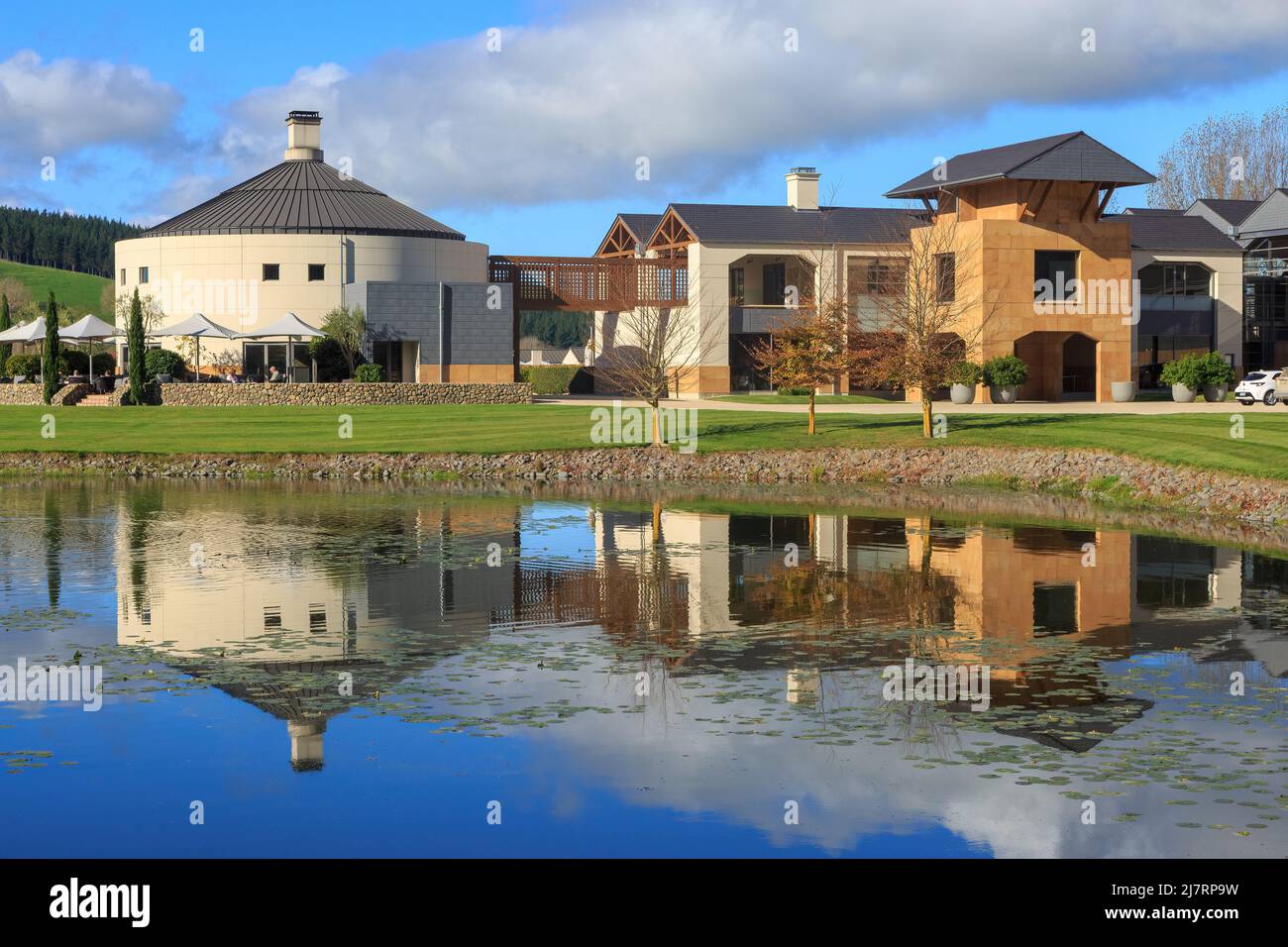 The restaurant at Craggy Ridge Winery in the Hawke's Bay region, New Zealand, reflected in the winery's ornamental lake Stock Photo