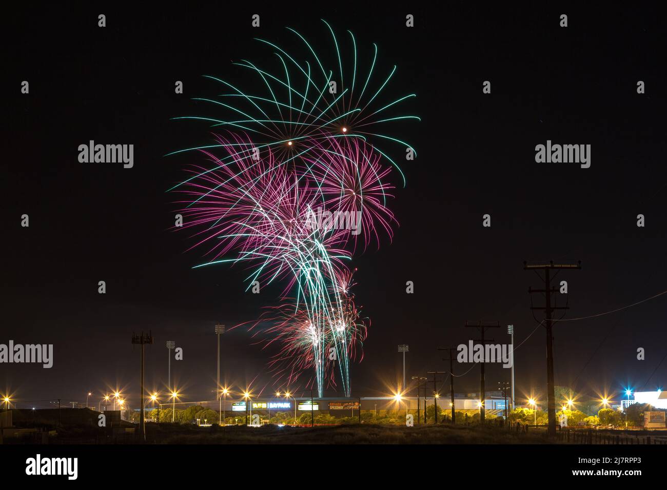 Fireworks bursting in the night sky above Baypark Speedway, a racing venue in Mount Maunagnui, New Zealand Stock Photo