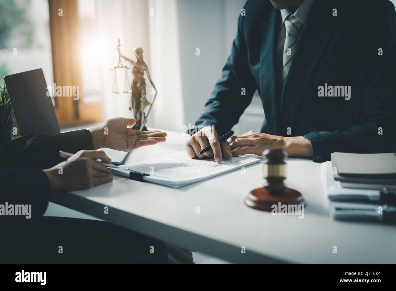 Law, Consultation, Agreement, Contract, Attorney or Lawyer holding a pen is consulting with a client to explain the pattern of answering questions Stock Photo