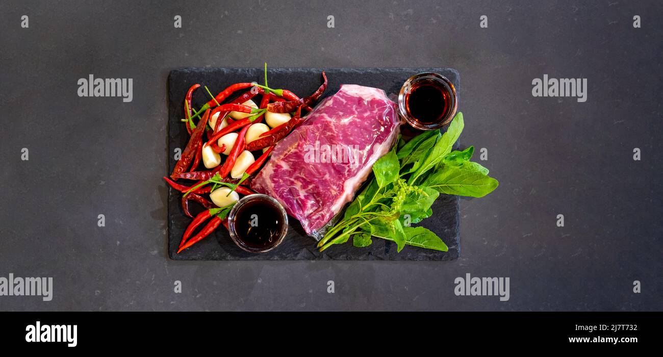 Top table, flatlay of Raw Beef herb ingredients, basil, garlic, chilli